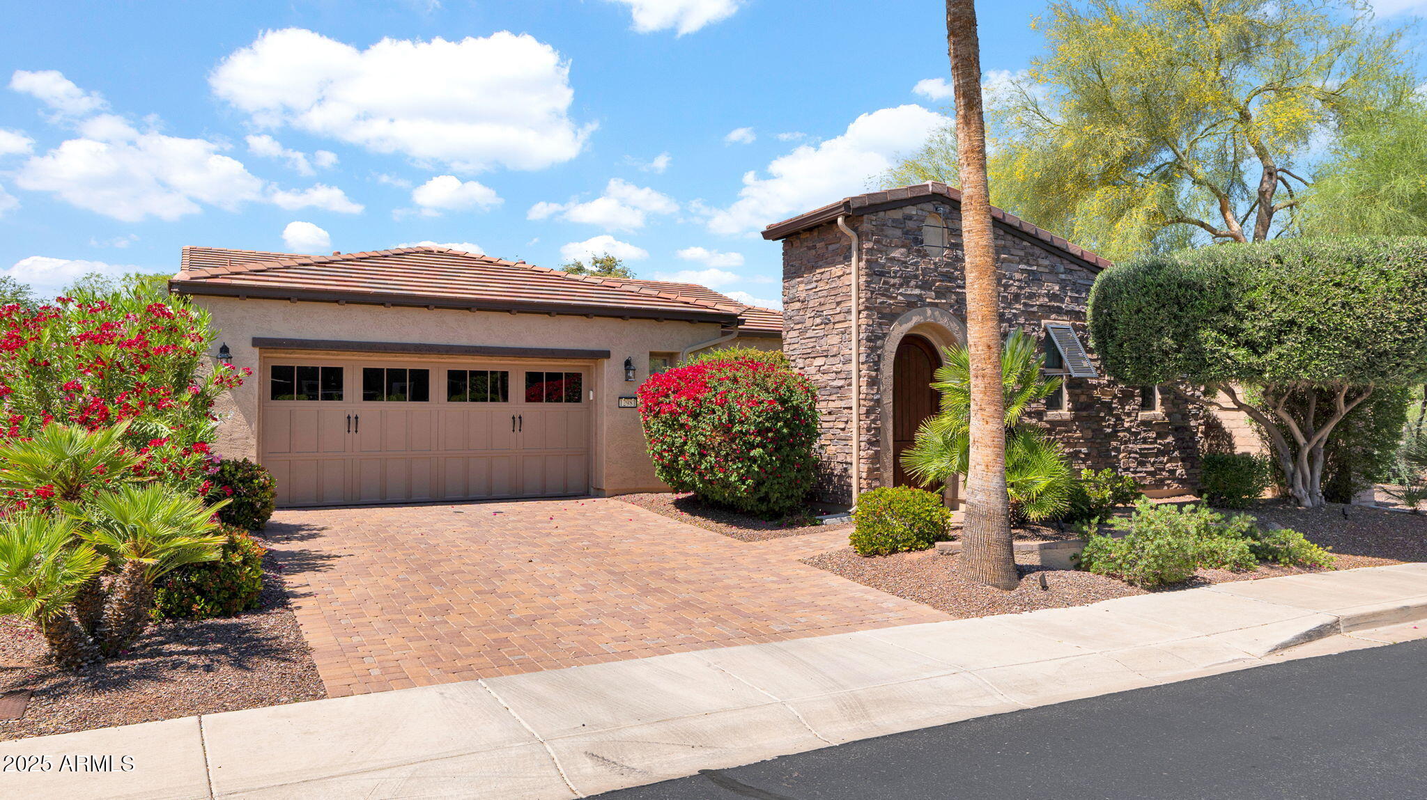 12981 West Yellow Bird Lane Peoria, AZ 85383 - Photo 1 of 47 a front view of a house with a garden