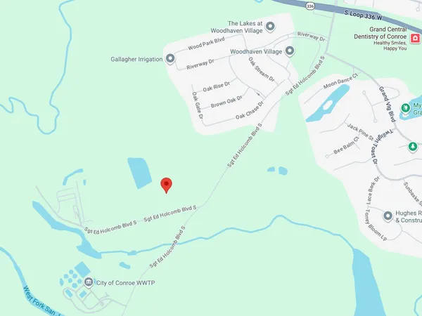 a white bath tub sitting next to a white wall and a clock