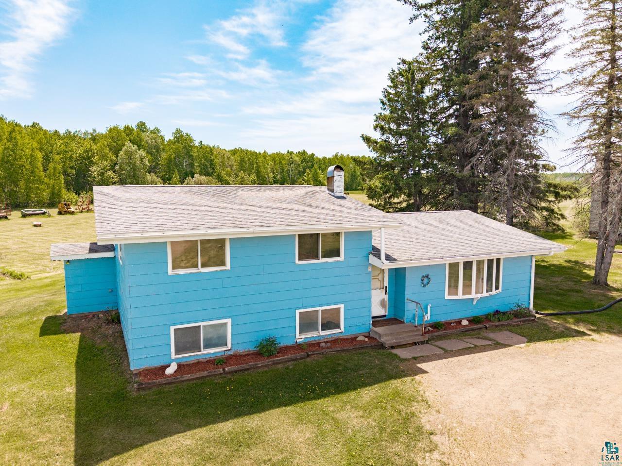 6606 Metso Road Kettle River, MN 55757 - Photo 1 of 84 Blue exterior with white trim, featuring a light gray shingled roof and multiple windows