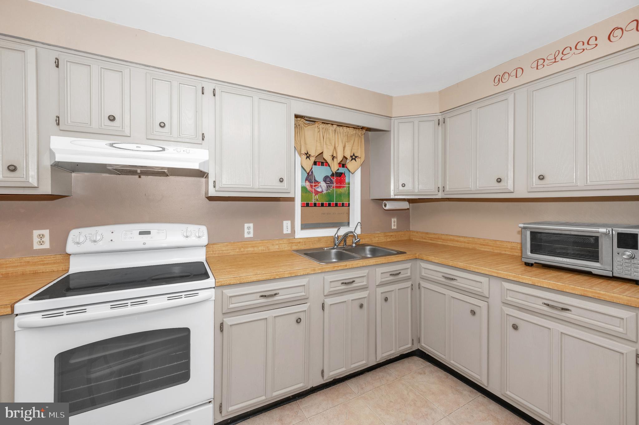 13411 Rabbit Run Terrace Union Bridge, MD 21791 - Photo 13 of 47 a kitchen with cabinets appliances a sink and a counter top
