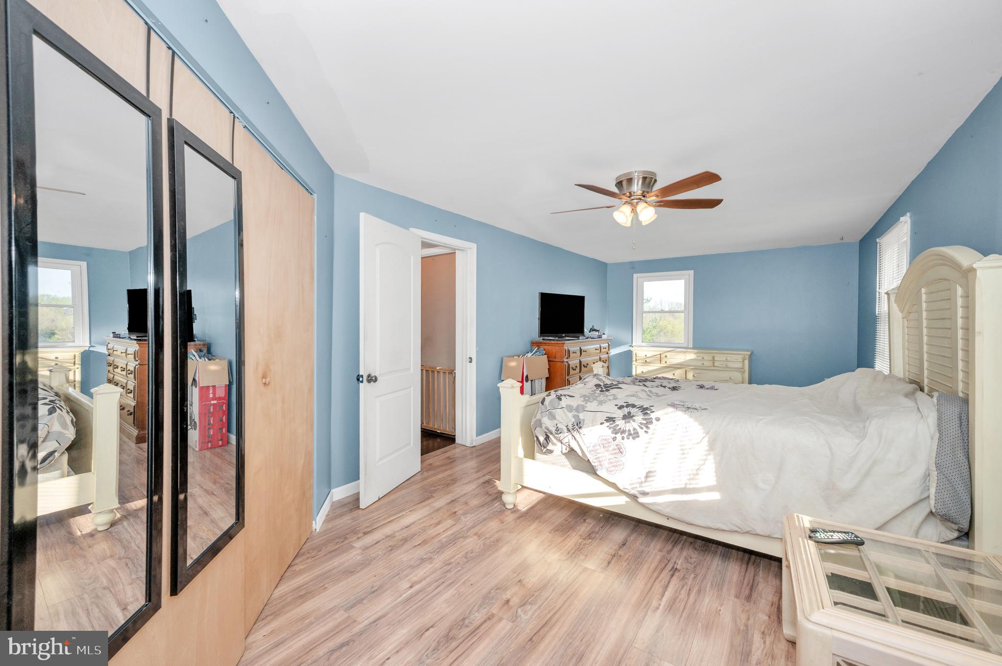 13411 Rabbit Run Terrace Union Bridge, MD 21791 - Photo 17 of 47 a view of a bedroom with wooden floor and a ceiling fan