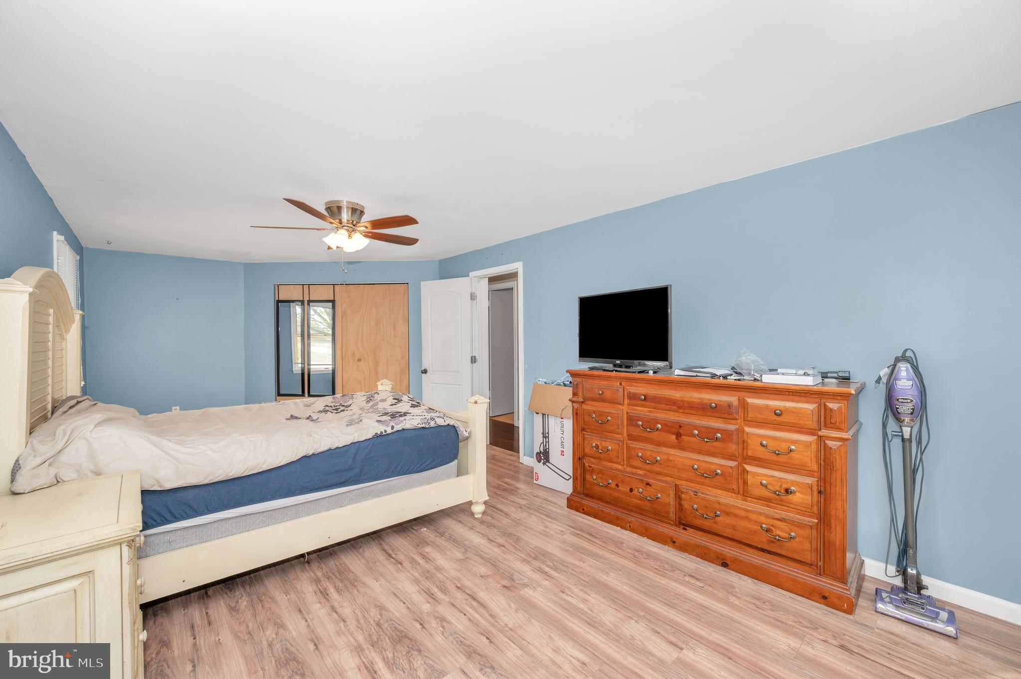 13411 Rabbit Run Terrace Union Bridge, MD 21791 - Photo 19 of 47 a bedroom with a bed and wooden floor