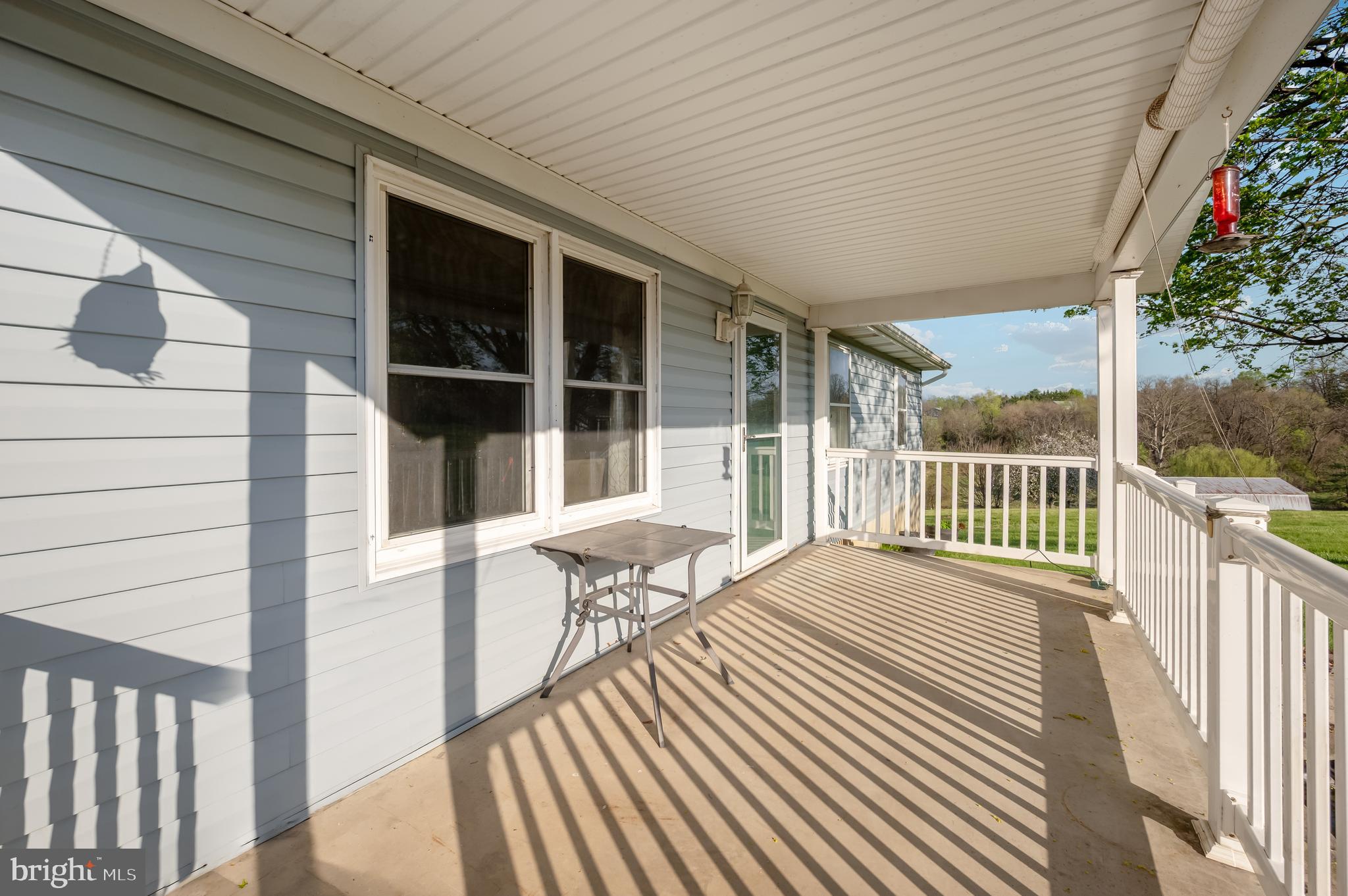 13411 Rabbit Run Terrace Union Bridge, MD 21791 - Photo 40 of 47 a balcony with wooden floor table and chairs