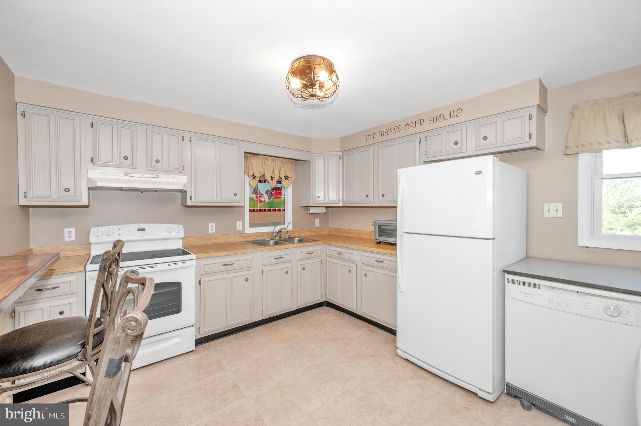 13411 Rabbit Run Terrace Union Bridge, MD 21791 - Photo 7 of 47 a kitchen with cabinets and white appliances