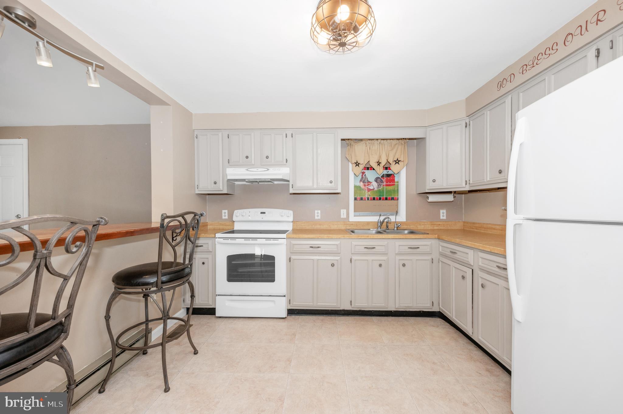 13411 Rabbit Run Terrace Union Bridge, MD 21791 - Photo 9 of 47 a kitchen with cabinets appliances and a window
