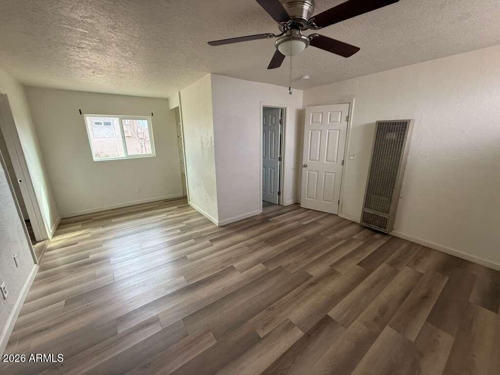 1258 East 15th Street Douglas, AZ 85607 - Photo 6 of 15 wooden floor in an empty room with a window