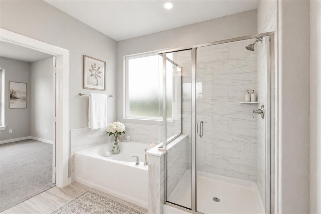 3311 Willena Road Melissa, TX 75454 - Photo 13 of 40 Bathroom featuring a built-in soaking tub with a window above, a separate glass-enclosed shower with tile surround, and light wood-finish flooring