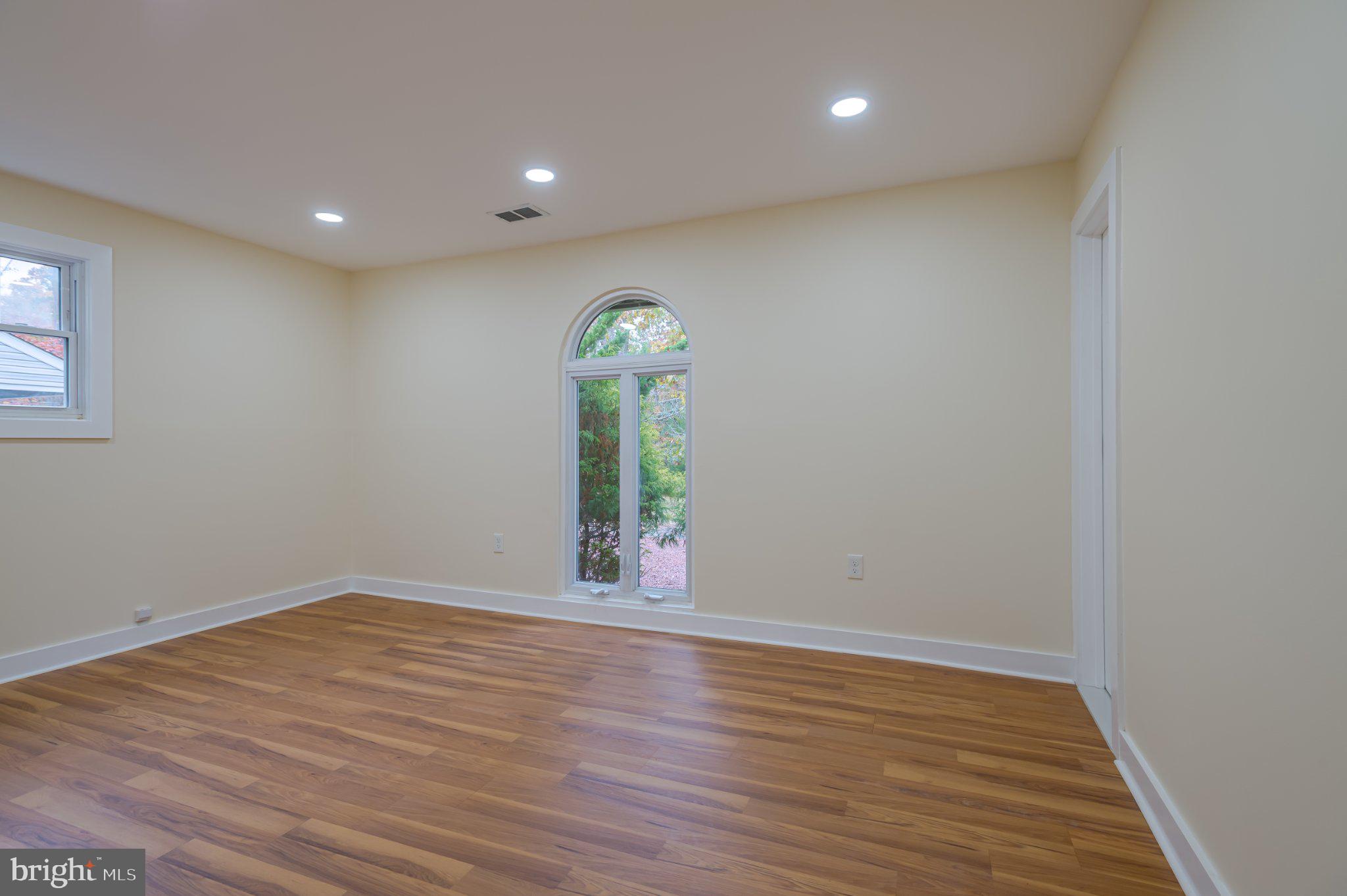 104 Hopewell Road Marlton, NJ 08053 - Photo 21 of 27 an empty room with wooden floor and windows