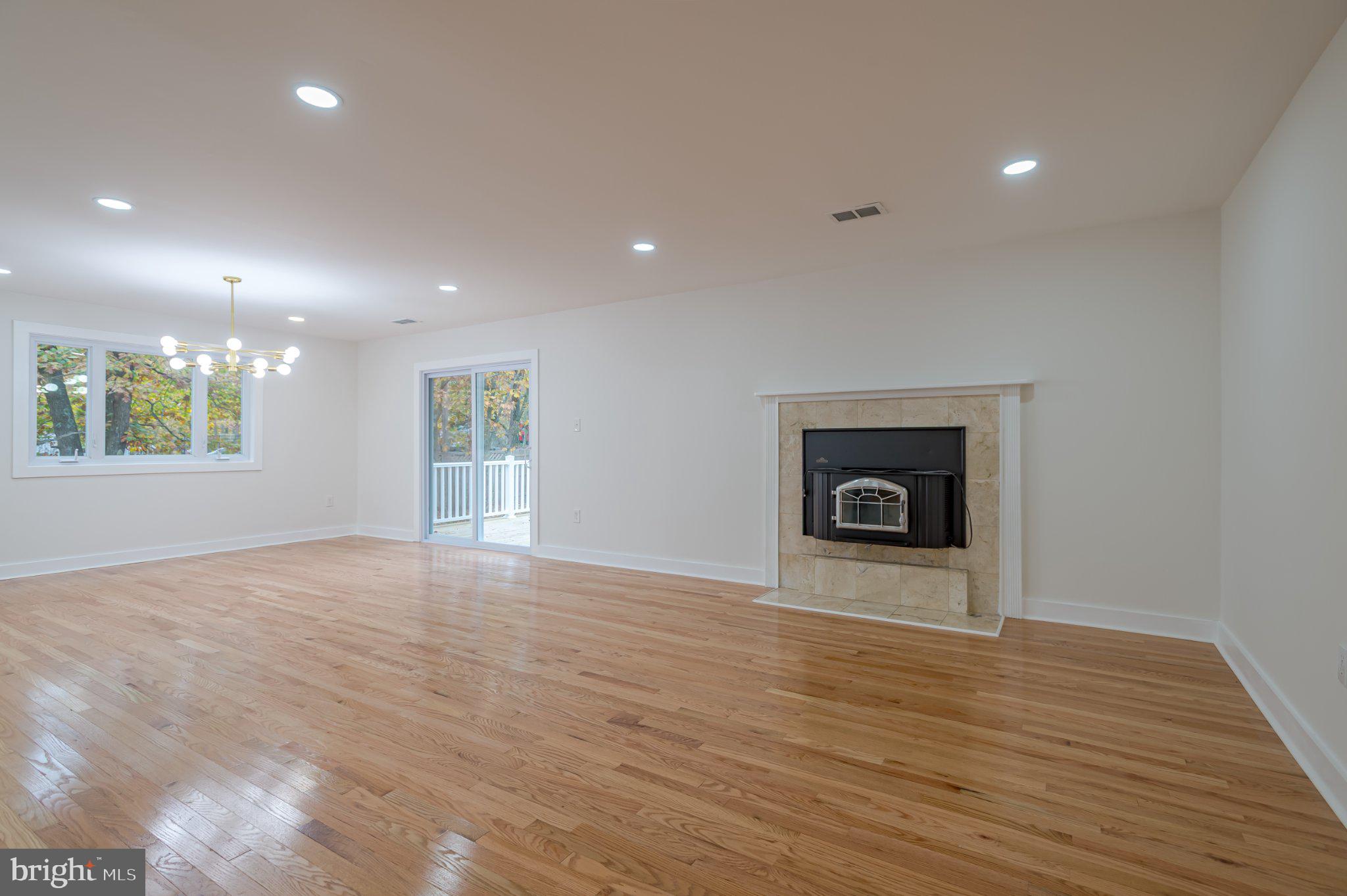 104 Hopewell Road Marlton, NJ 08053 - Photo 5 of 27 a view of an empty room with a fireplace and a window