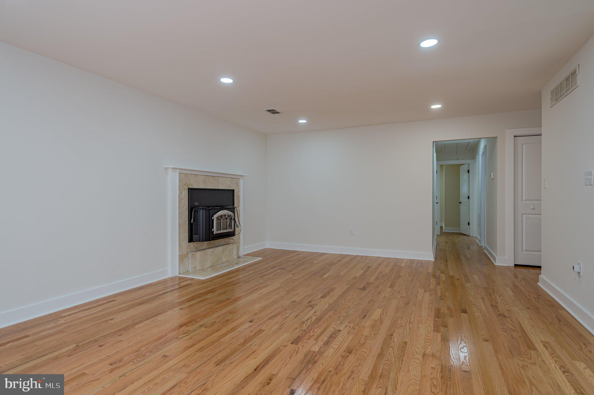 104 Hopewell Road Marlton, NJ 08053 - Photo 7 of 27 a view of an empty room with wooden floor and a window