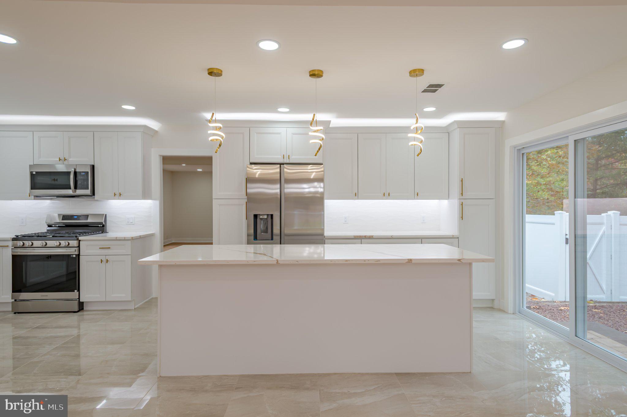 104 Hopewell Road Marlton, NJ 08053 - Photo 10 of 27 a large kitchen with stainless steel appliances kitchen island a large counter top and a refrigerator