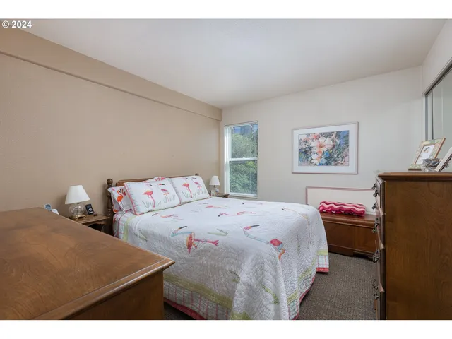 a bedroom with a bed and a desk