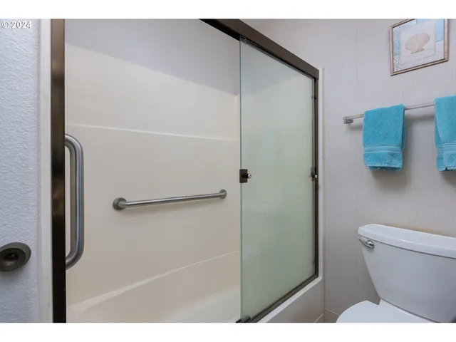 a bathroom with a shower and a toilet