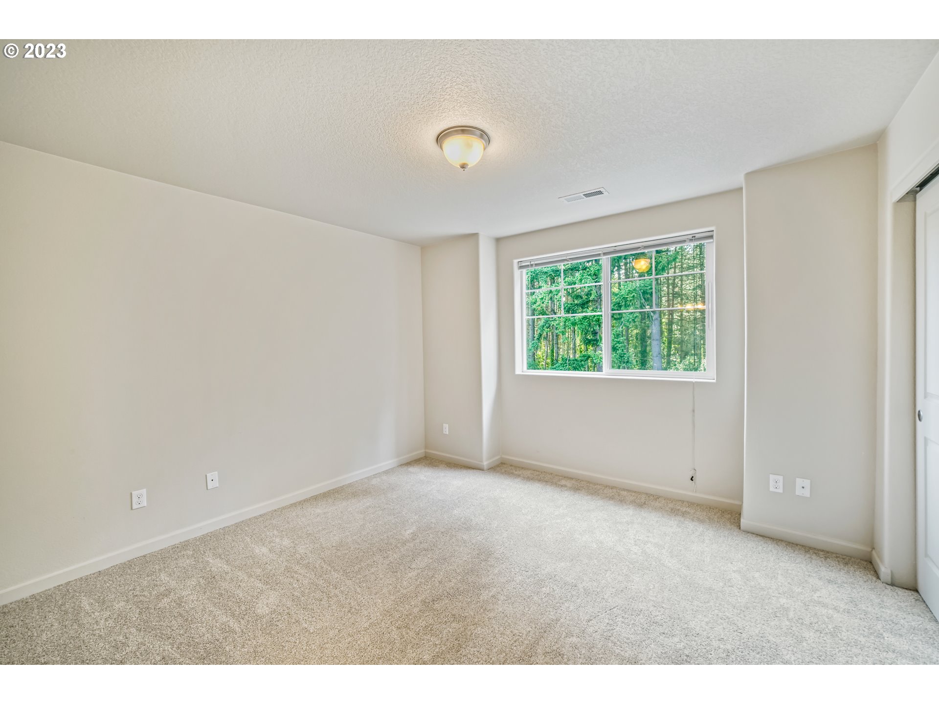 10595 Northeast Cedar Falls Loop Hillsboro, OR 97006 - Photo 13 of 27 a view of an empty room with a window