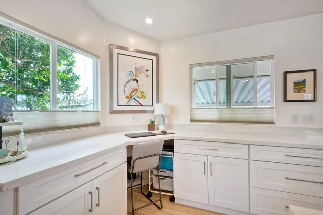 a kitchen with stainless steel appliances granite countertop a stove a sink dishwasher and white cabinets with wooden floor