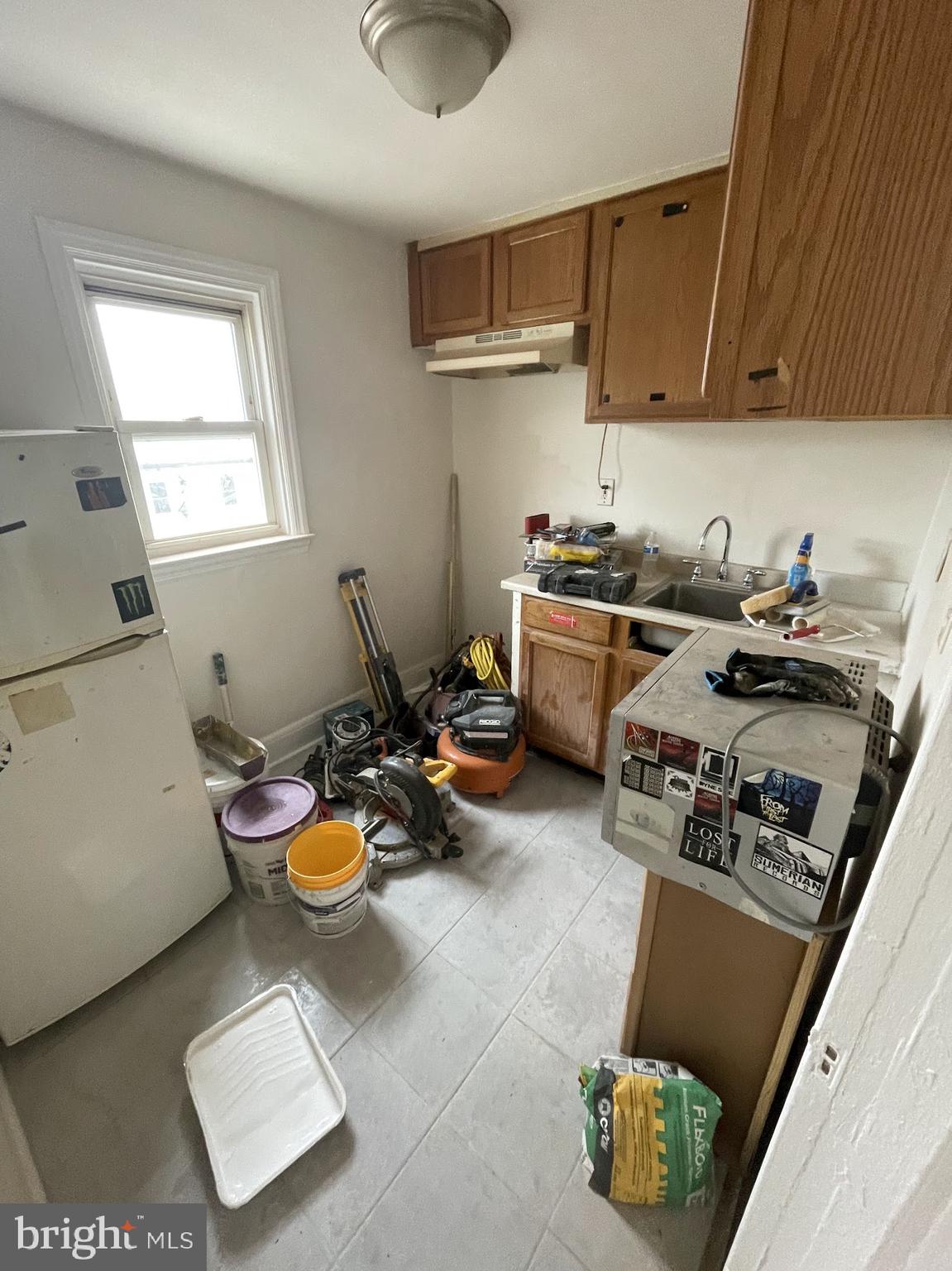 100 Willow Spring Road Dundalk, MD 21222 - Photo 2 of 8 a kitchen with sink refrigerator and stove
