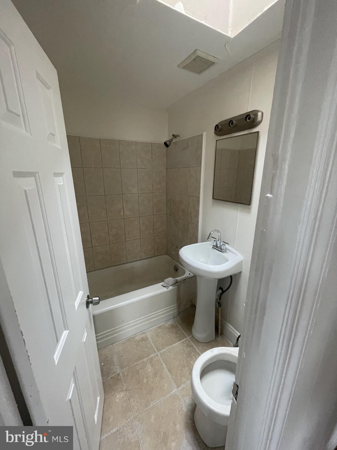 100 Willow Spring Road Dundalk, MD 21222 - Photo 3 of 8 a bathroom with a sink toilet and a mirror