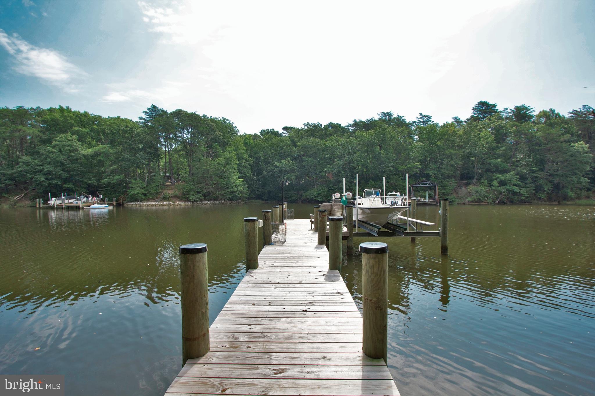 13422 Olivet Road Lusby, MD 20657 - Photo 20 of 23 a wooden pier with boats in a lake