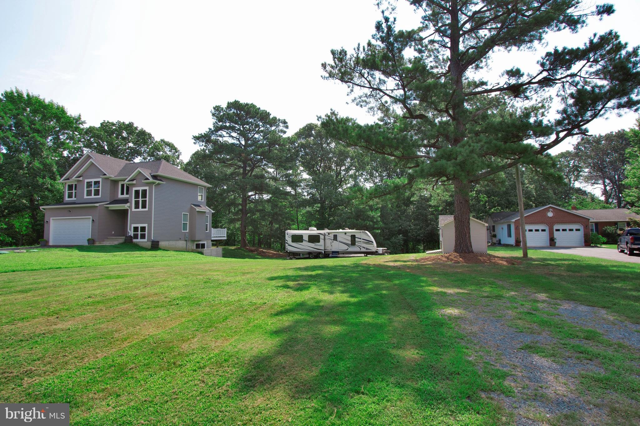 13422 Olivet Road Lusby, MD 20657 - Photo 4 of 23 a front view of a house with a garden