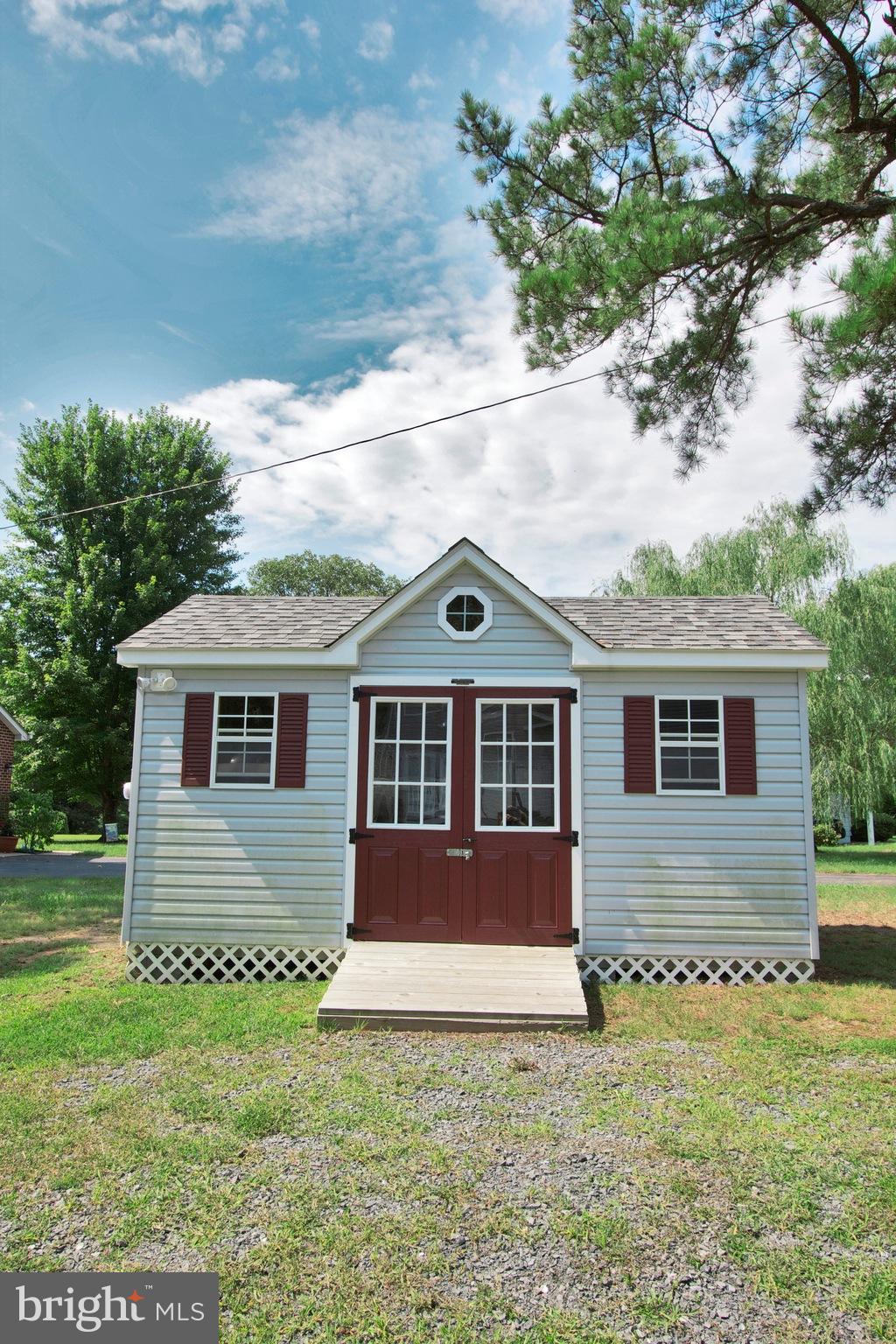 13422 Olivet Road Lusby, MD 20657 - Photo 6 of 23 a front view of a house with a garden