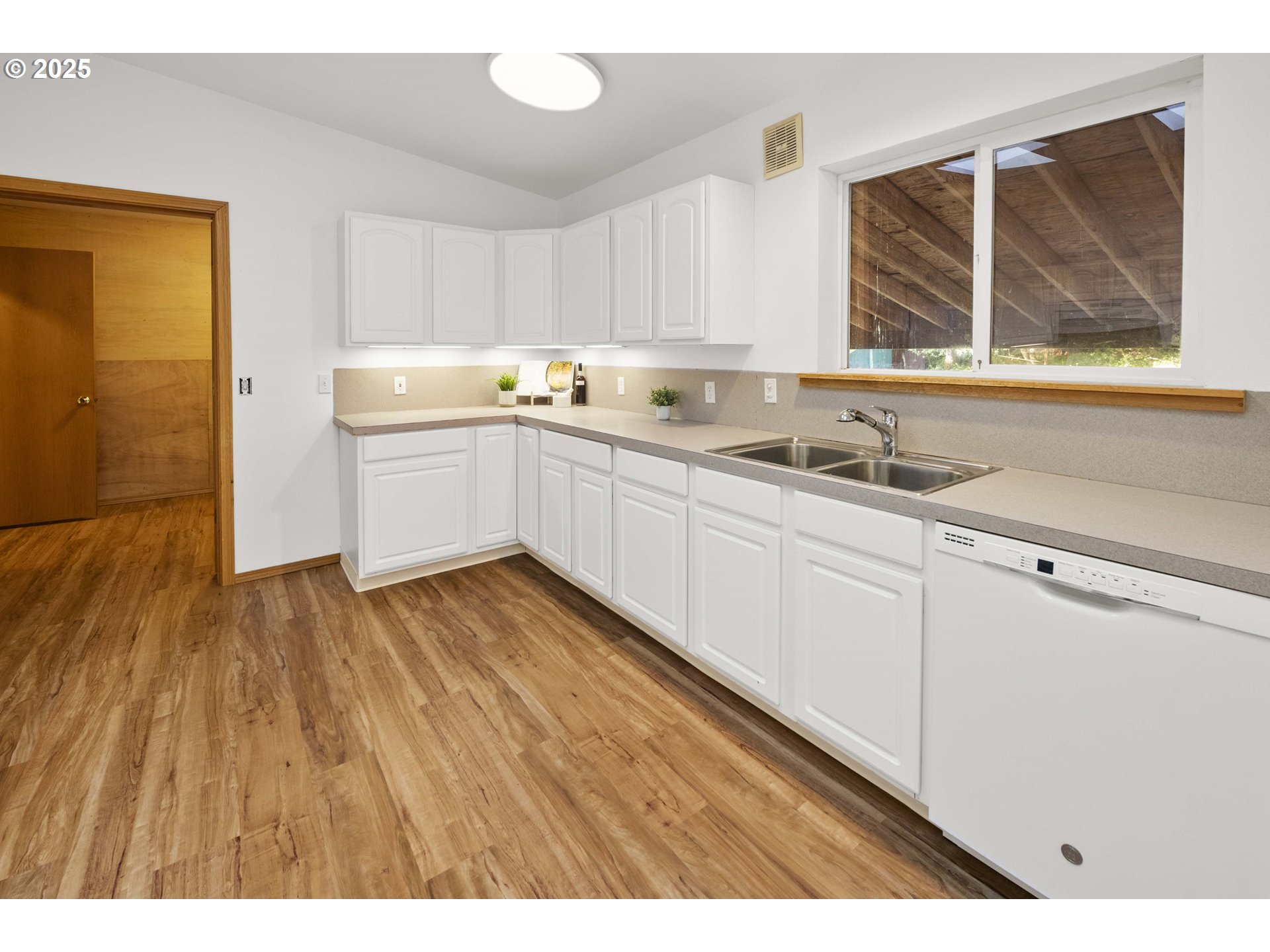89022 Welch Road Astoria, OR 97103 - Photo 17 of 42 a kitchen with wooden floors and white appliances