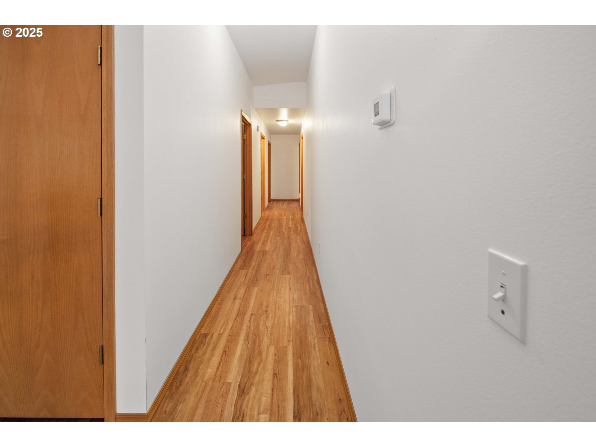 89022 Welch Road Astoria, OR 97103 - Photo 18 of 42 a view of a hallway with wooden floor