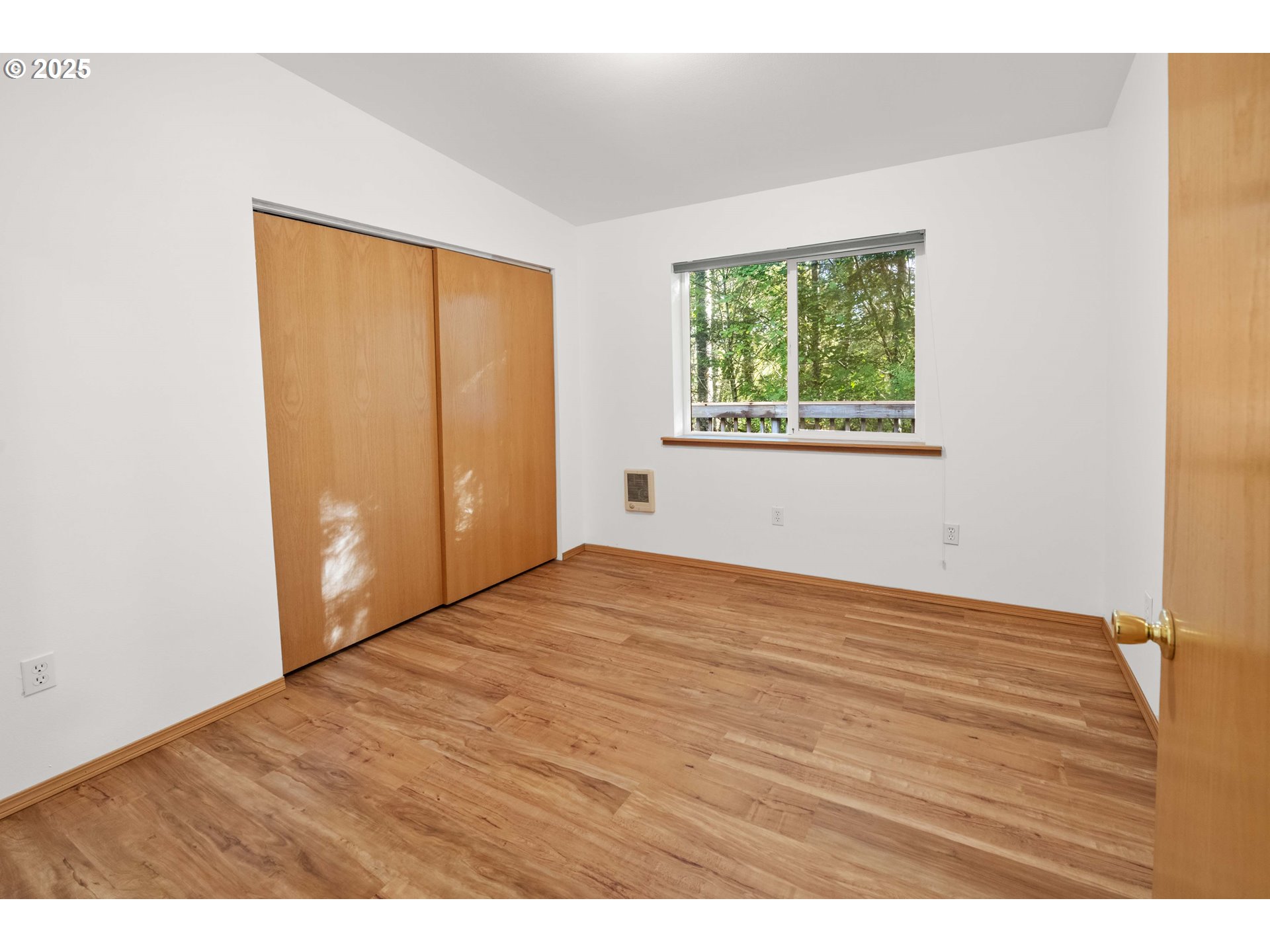 89022 Welch Road Astoria, OR 97103 - Photo 19 of 42 a view of an empty room with wooden floor and a window