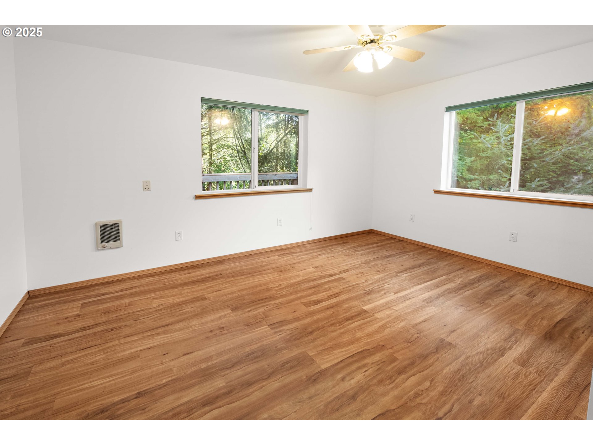 89022 Welch Road Astoria, OR 97103 - Photo 23 of 42 an empty room with wooden floor and windows