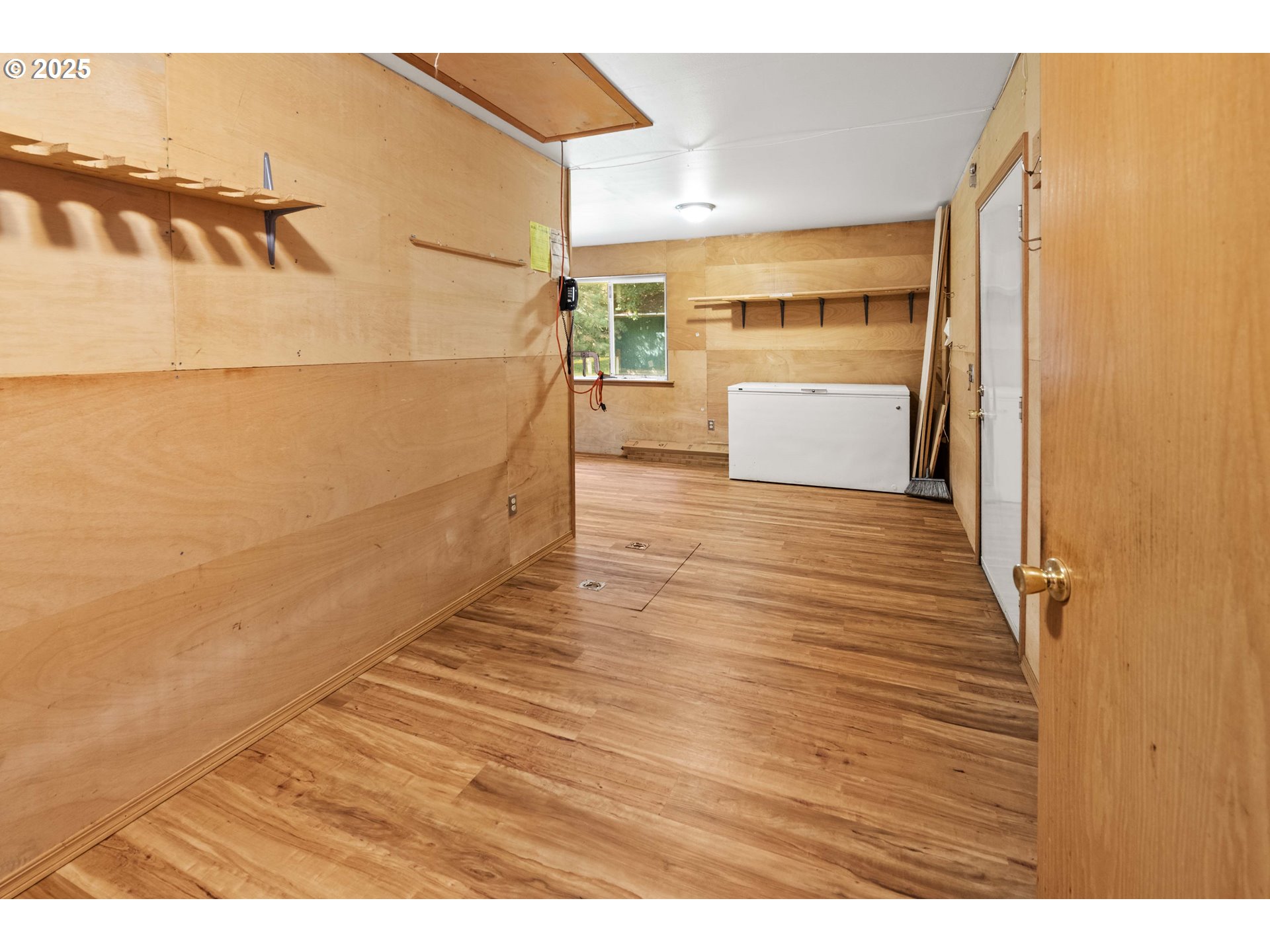 89022 Welch Road Astoria, OR 97103 - Photo 26 of 42 a view of a room with wooden floor and a refrigerator