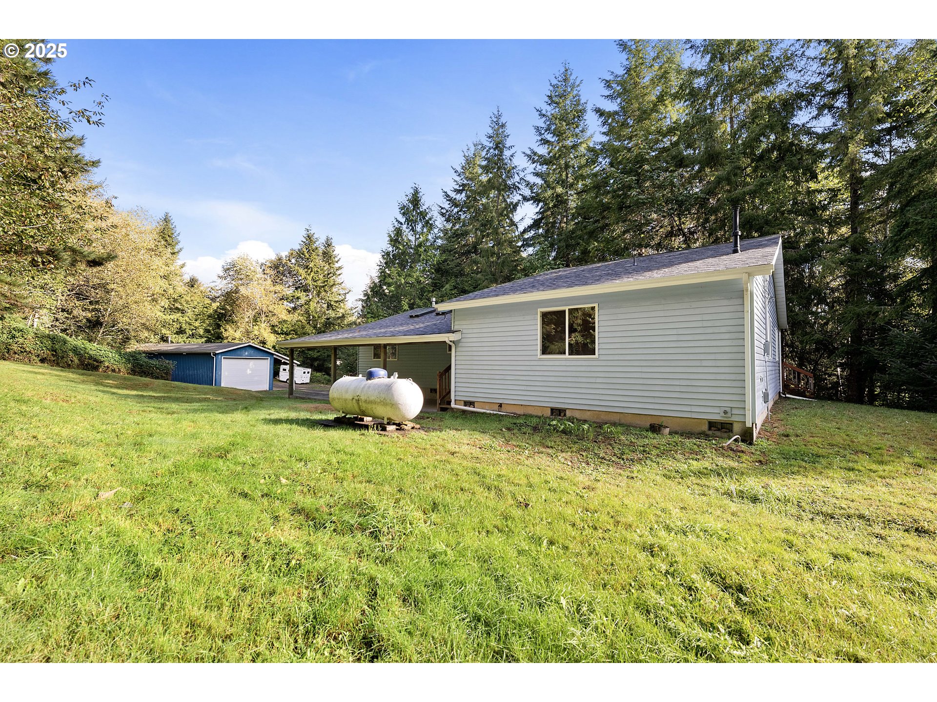 89022 Welch Road Astoria, OR 97103 - Photo 29 of 42 a backyard of a house with plants and tree