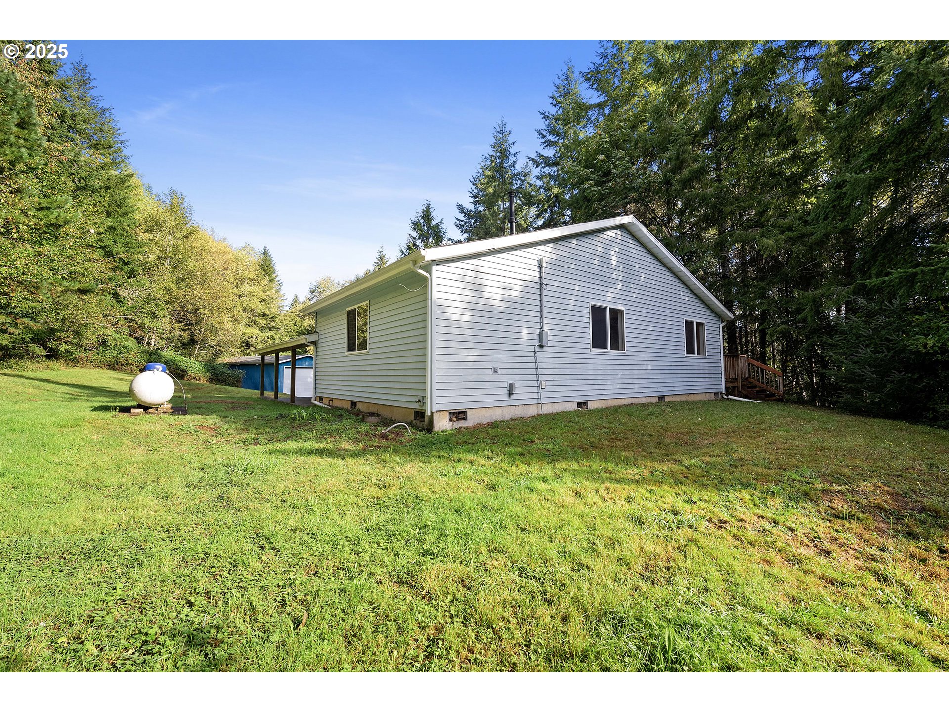 89022 Welch Road Astoria, OR 97103 - Photo 30 of 42 a view of a backyard with a garden