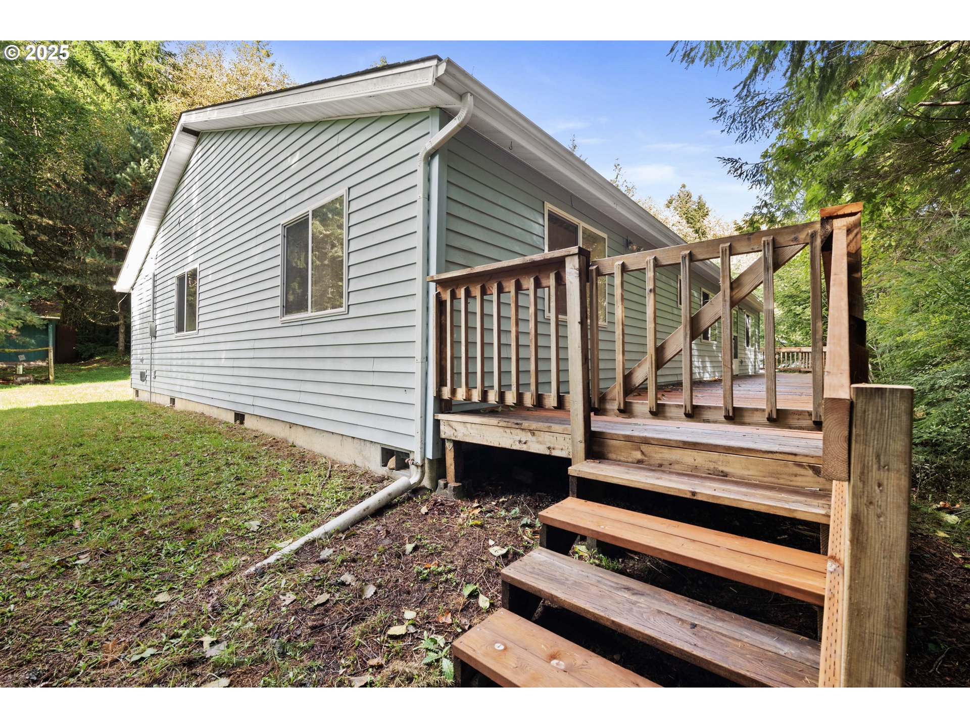 89022 Welch Road Astoria, OR 97103 - Photo 31 of 42 a view of a house with a bed and wooden fence