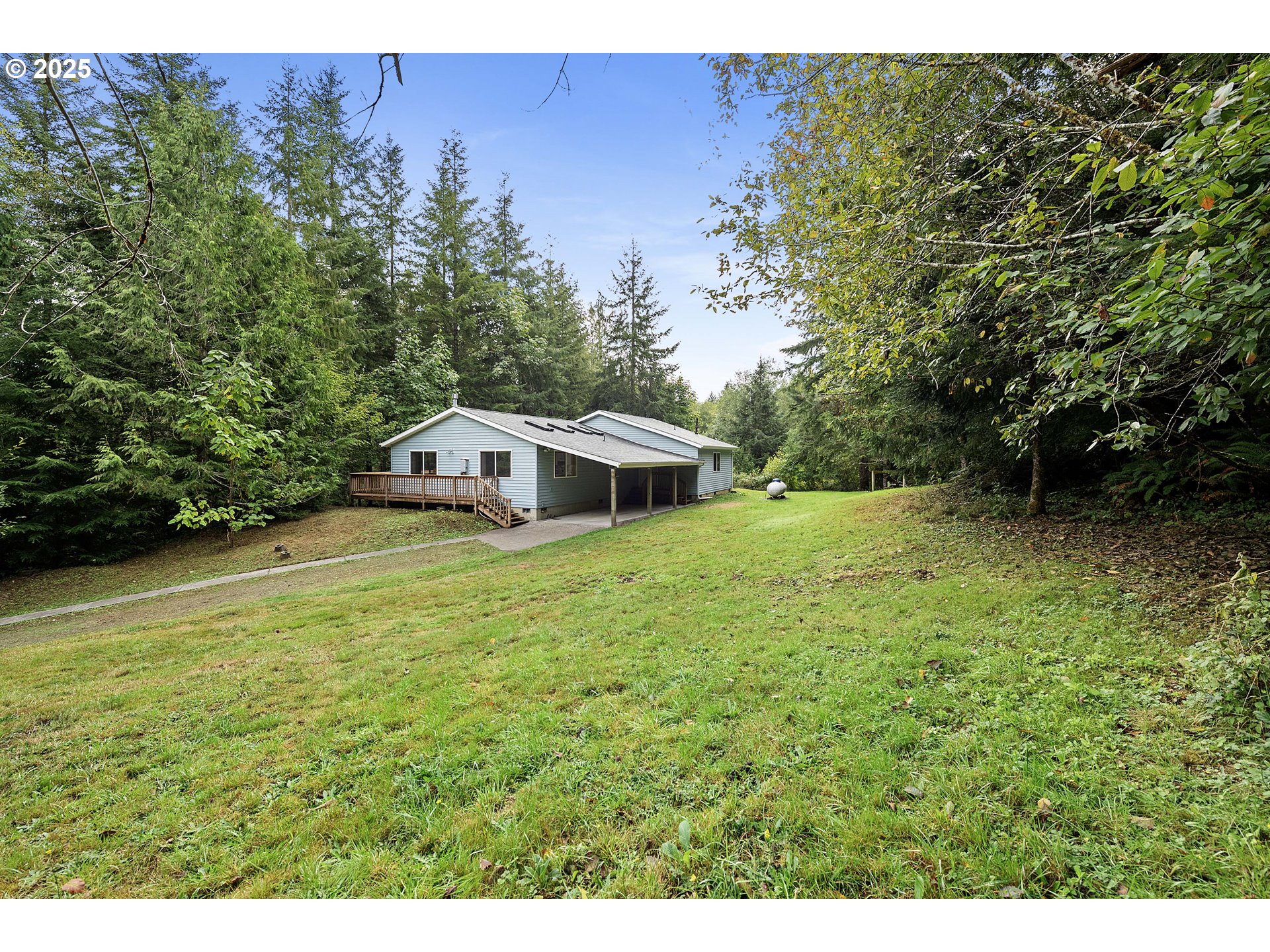 89022 Welch Road Astoria, OR 97103 - Photo 39 of 42 a white house with a big yard and large trees