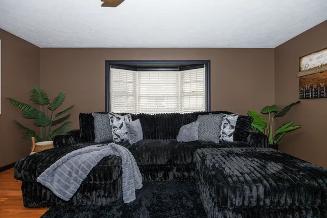 a dining room with furniture a chandelier and wooden floor