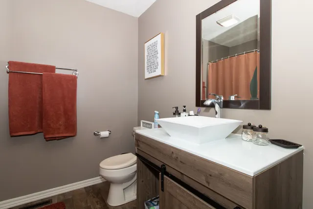 a bedroom with a bed a flat screen tv and a fireplace