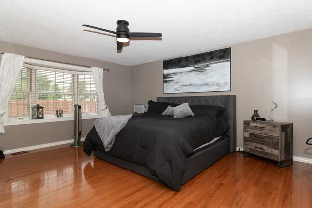 a bed room with a bed and a chair