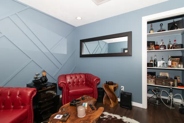 a view of a livingroom with furniture and a fan