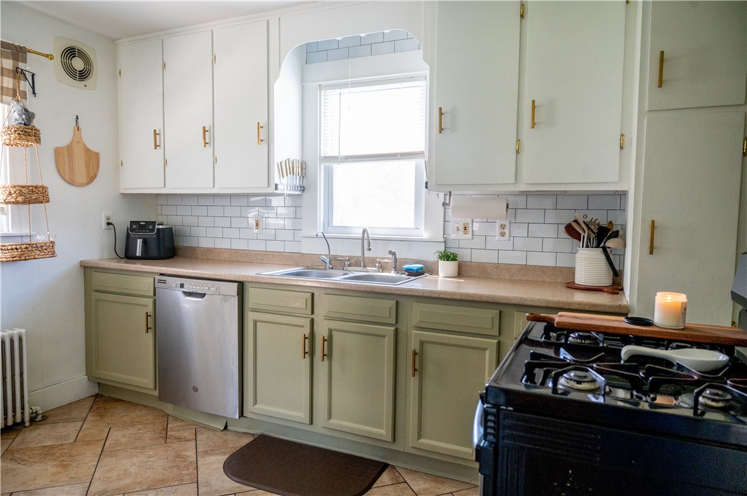 3365 Trapping Brook Road Wellsville, NY 14895 - Photo 11 of 47 The kitchen is on-trend with its pretty two-toned cabinets, gold hardware, and white ceramic subway tile backsplash. Don't overlook the attractive ceramic flooring with its interesting design.