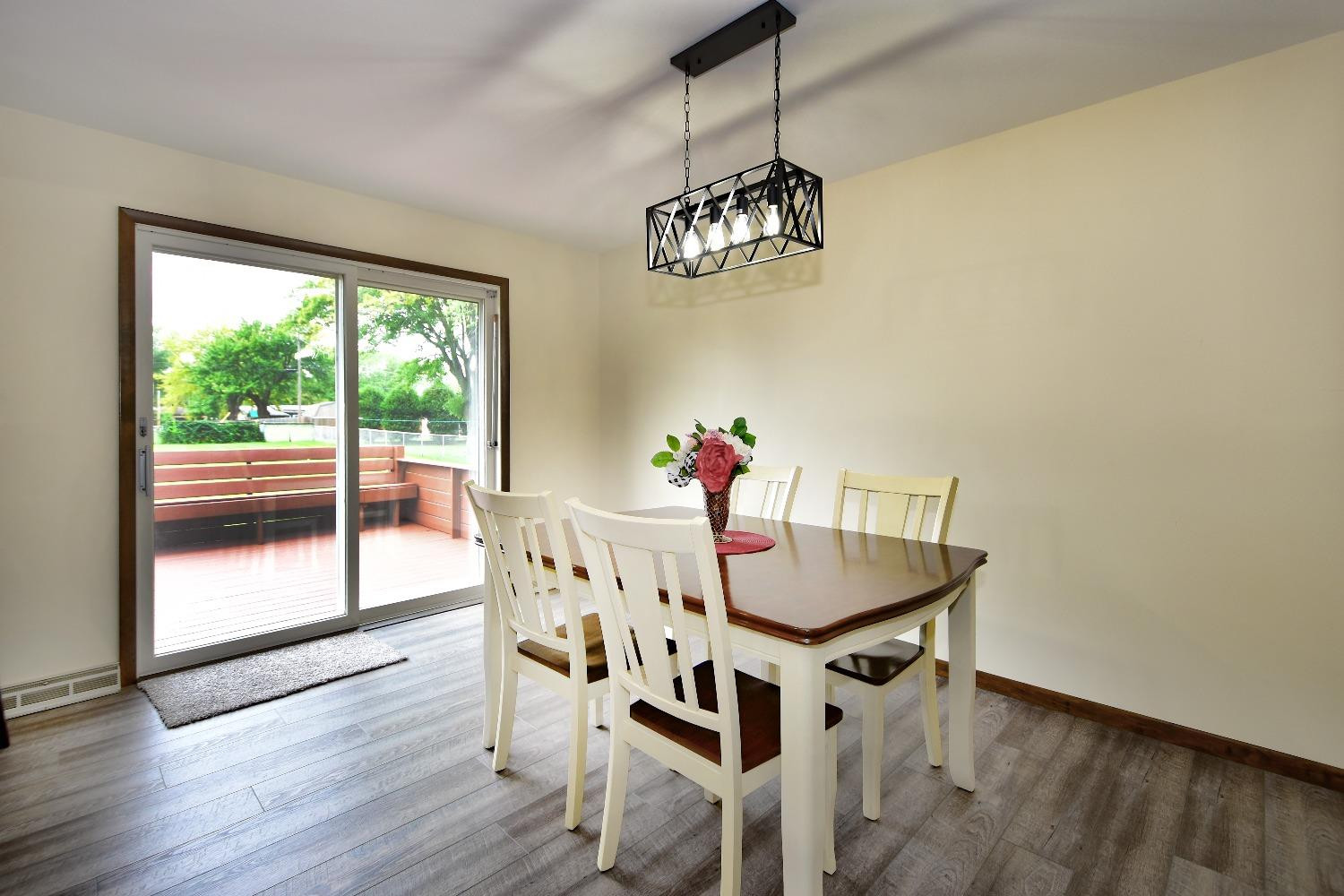 9020 Bryan Street Crown Point, IN 46307 - Photo 11 of 31 a view of a dining room with furniture wooden floor and chandelier