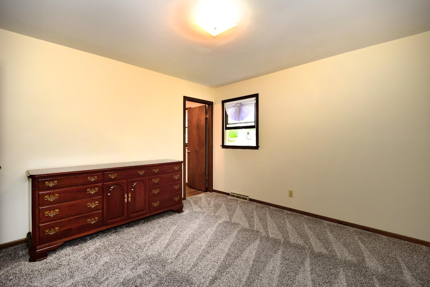 9020 Bryan Street Crown Point, IN 46307 - Photo 18 of 31 a room with a bed and a dresser