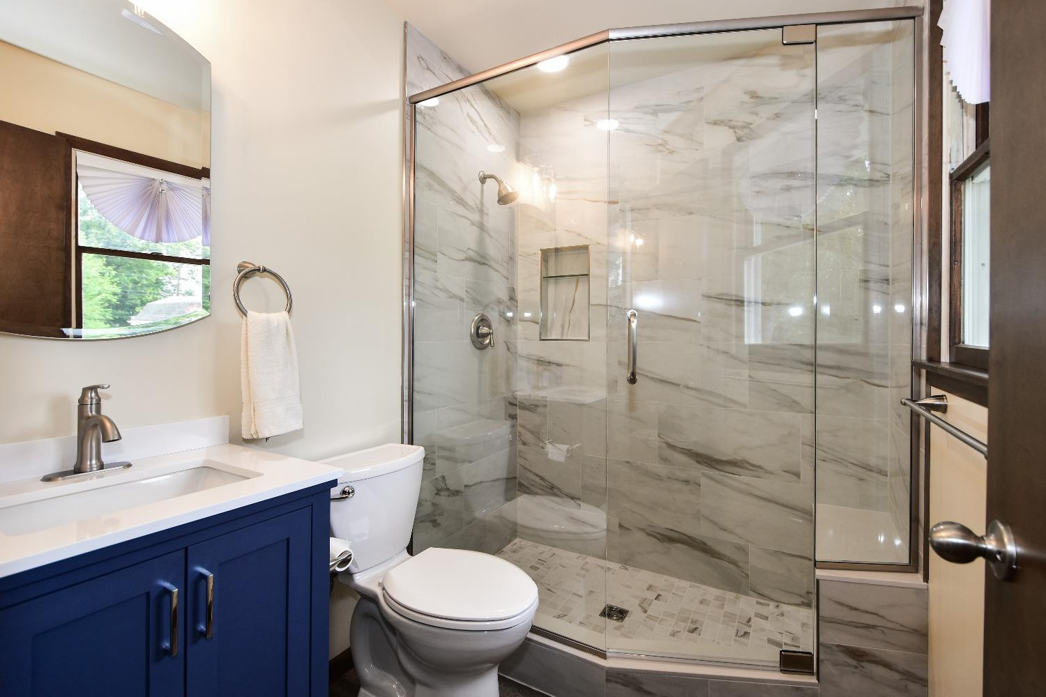 9020 Bryan Street Crown Point, IN 46307 - Photo 20 of 31 a bathroom with a shower sink vanity mirror and toilet