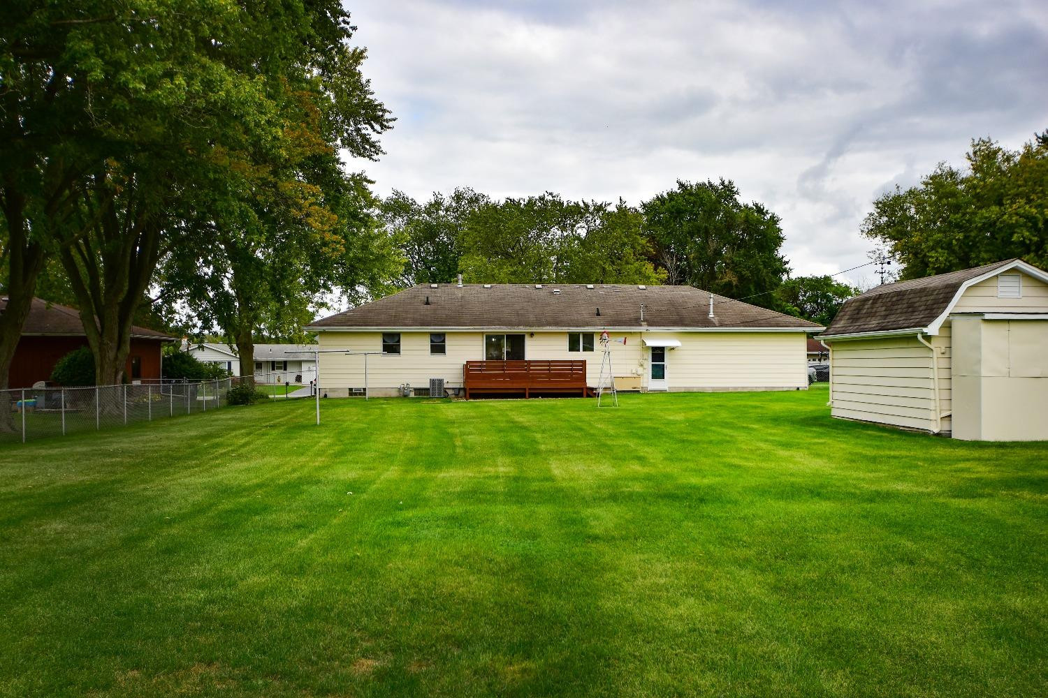 9020 Bryan Street Crown Point, IN 46307 - Photo 25 of 31 a view of a white house in front of a big yard with large trees