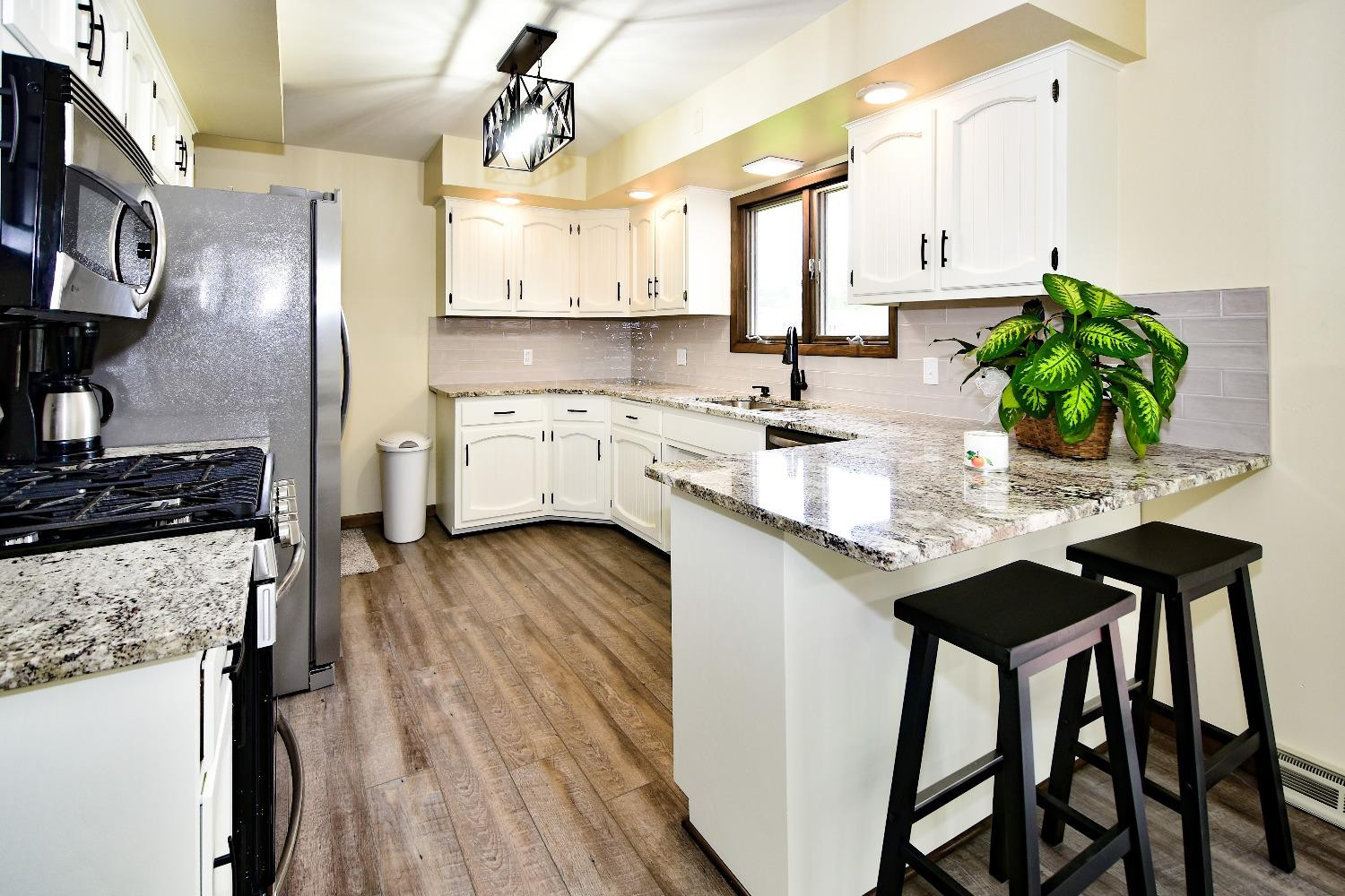 9020 Bryan Street Crown Point, IN 46307 - Photo 5 of 31 a kitchen with appliances cabinets dining table and chairs