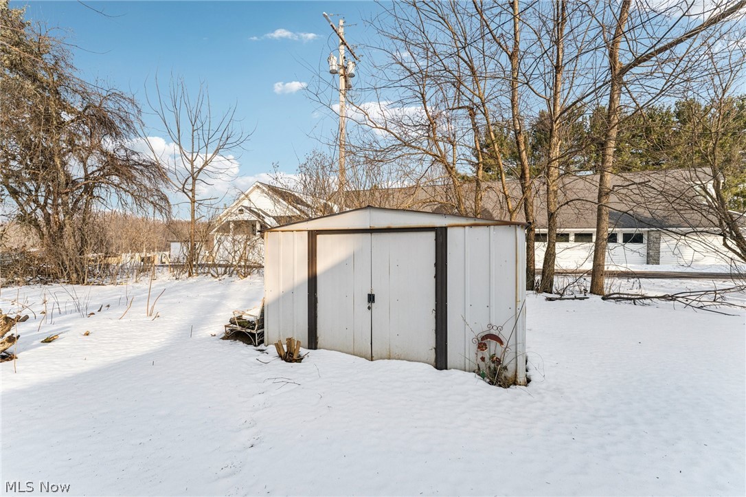15615 Mason Road Vermilion, OH 44089 - Photo 28 of 34 Snow covered structure with a storage shed