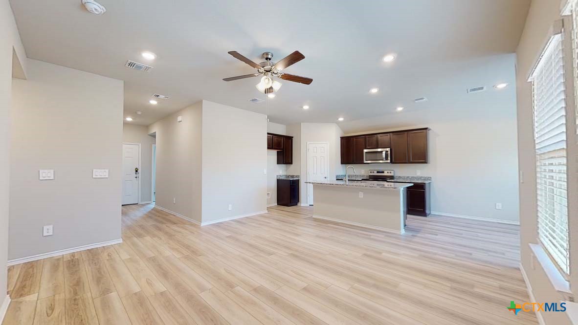 549 Hector Loop Georgetown, TX 78626 - Photo 3 of 22 a view of kitchen with microwave and refrigerator