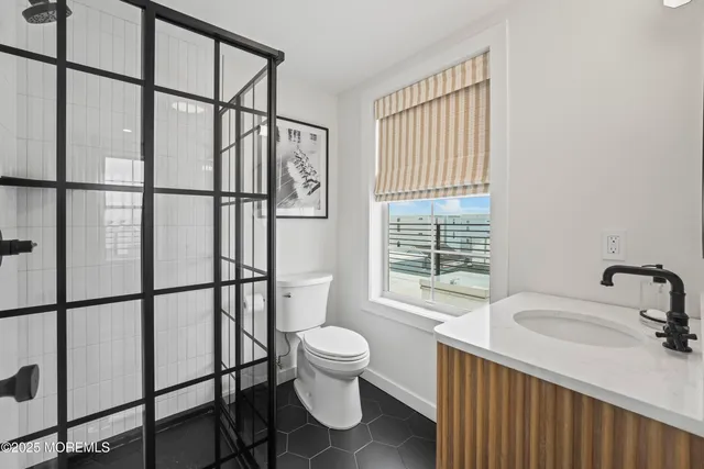 a bedroom with a bed and a night stand