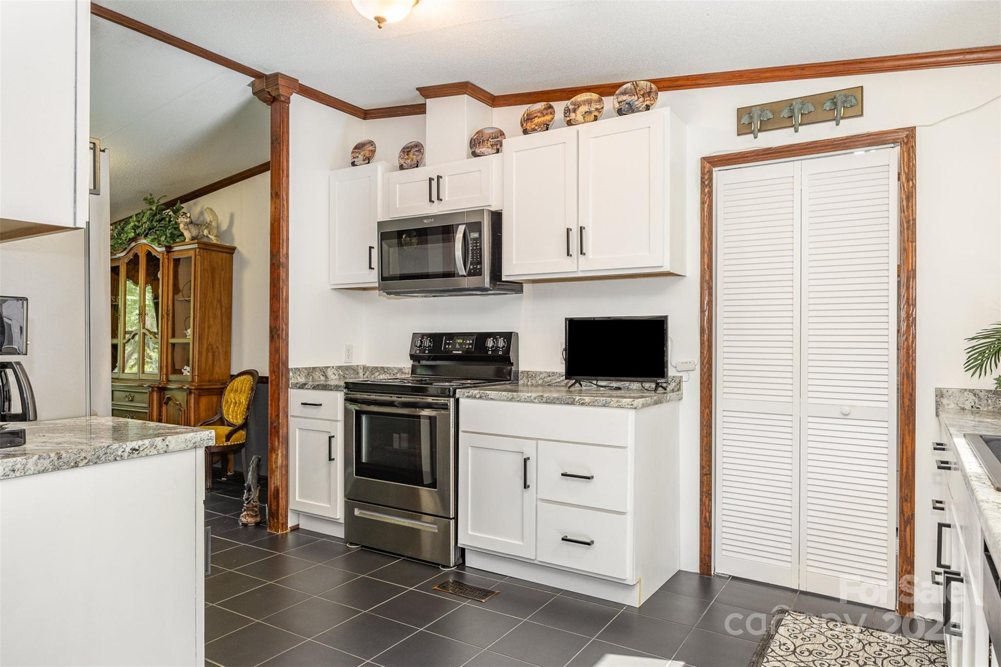 417 Old Tulip Farm Road Salisbury, NC 28147 - Photo 12 of 35 a kitchen with stainless steel appliances a stove microwave and a refrigerator