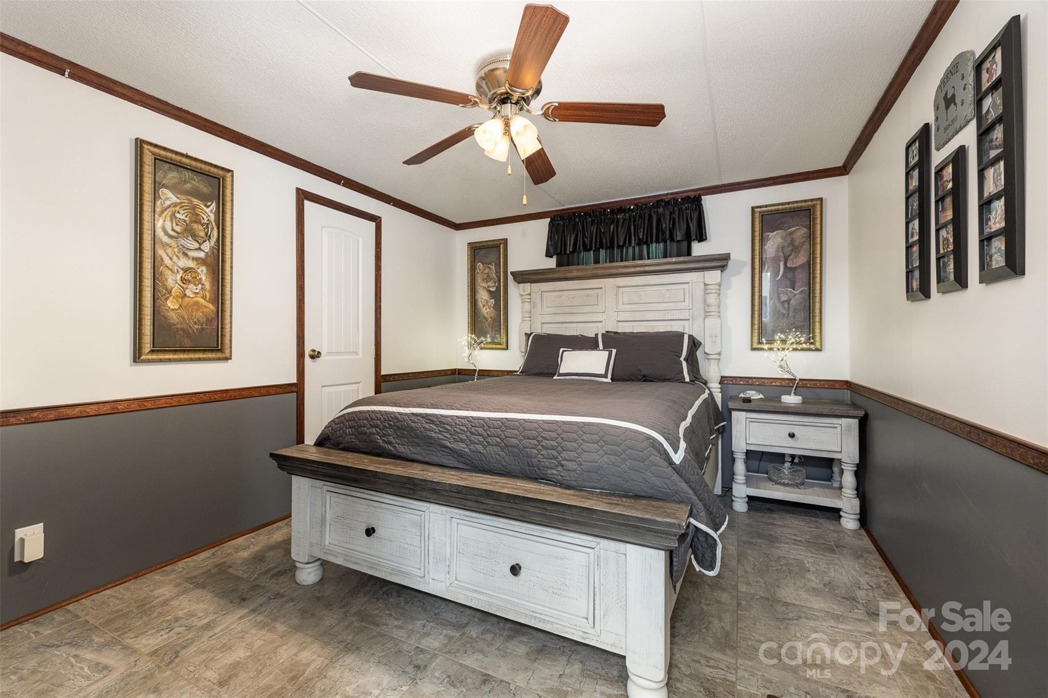 417 Old Tulip Farm Road Salisbury, NC 28147 - Photo 17 of 35 a bedroom with a large bed and a chandelier