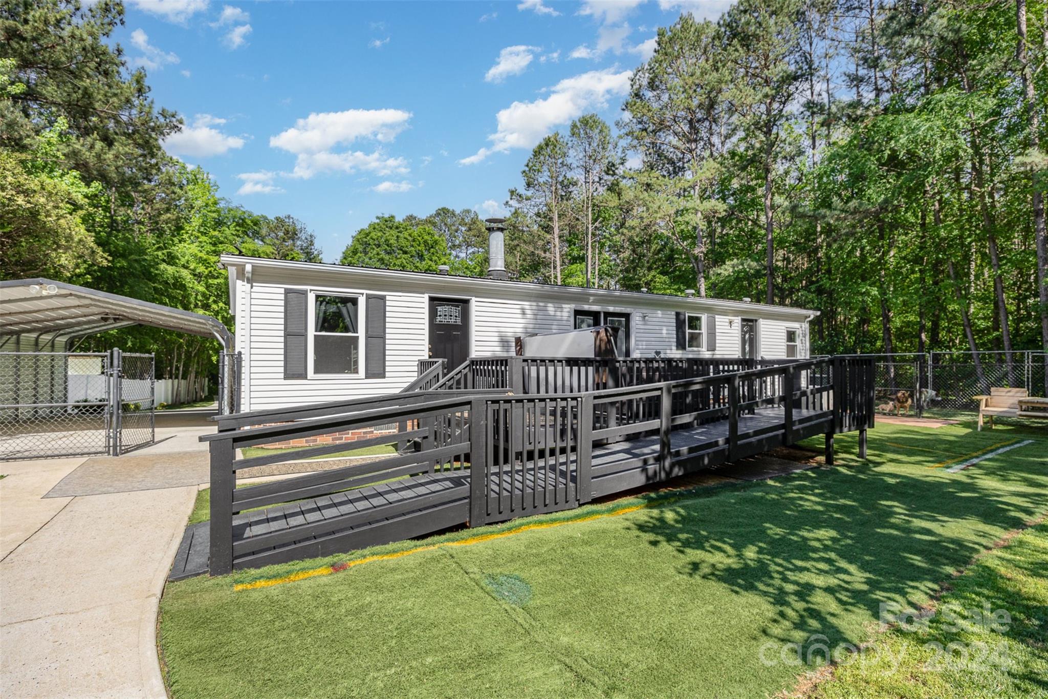417 Old Tulip Farm Road Salisbury, NC 28147 - Photo 26 of 35 a view of a house with wooden deck and a big yard