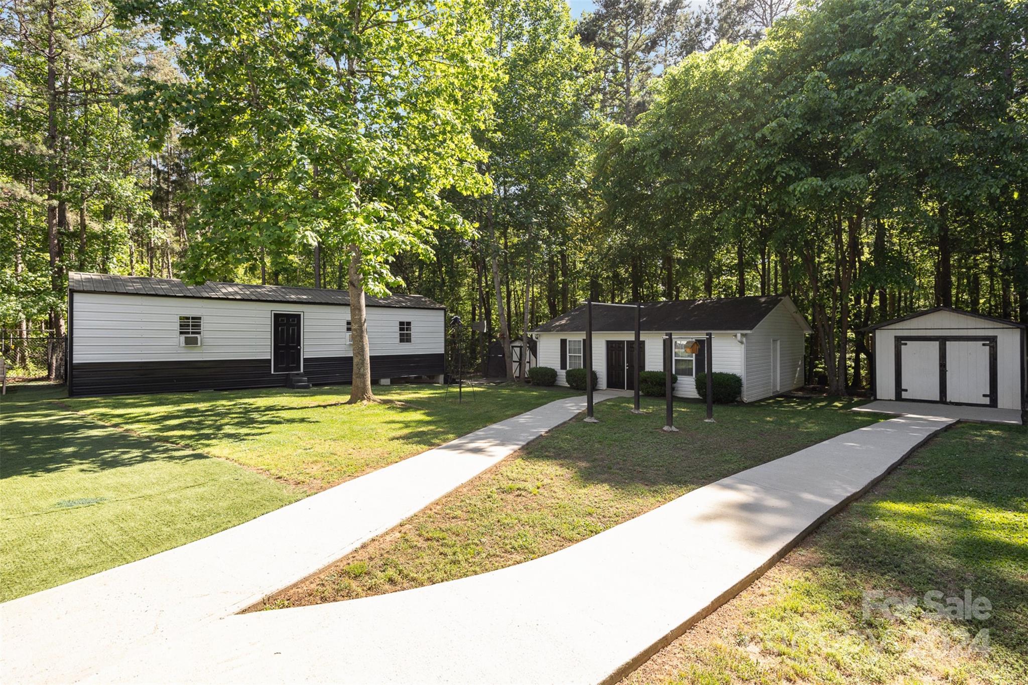 417 Old Tulip Farm Road Salisbury, NC 28147 - Photo 27 of 35 a view of a house with a yard patio and a small yard